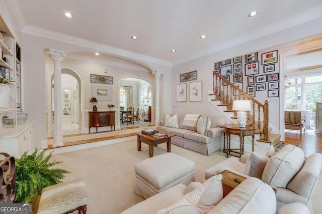 living room with ornamental molding, decorative columns, and light hardwood / wood-style floors