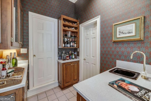 kitchen featuring light tile patterned floors and sink