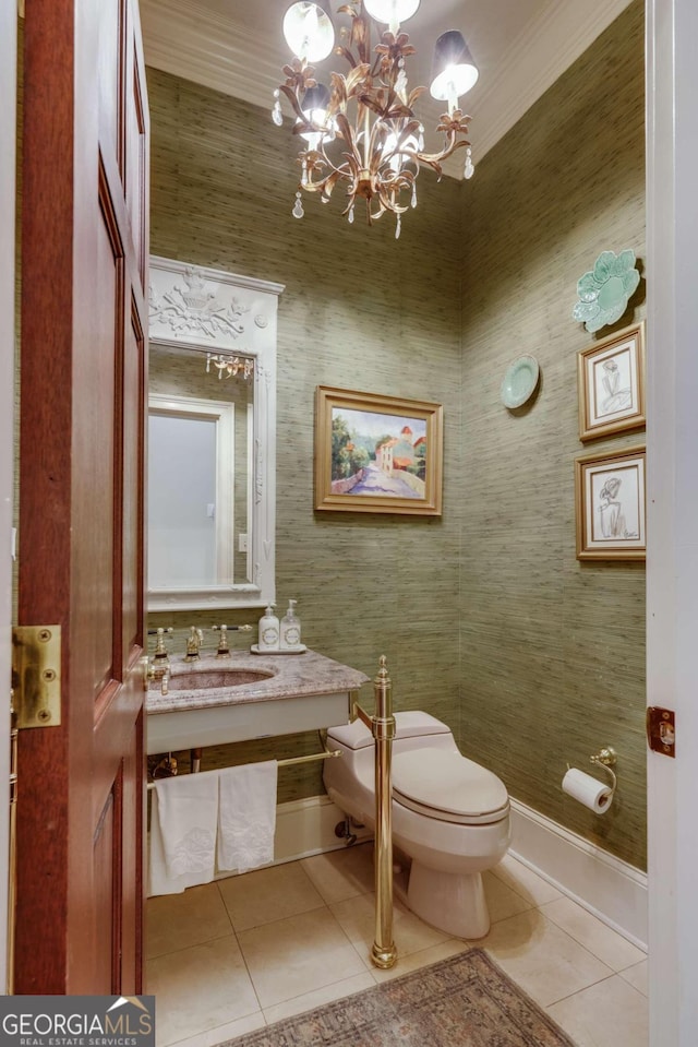 bathroom with crown molding, a chandelier, toilet, tile patterned floors, and sink