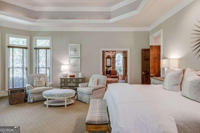 bedroom with carpet flooring, a raised ceiling, and crown molding