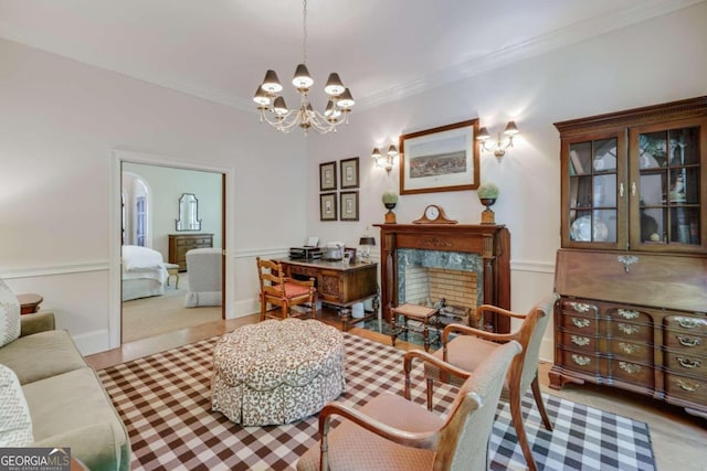 living room featuring ornamental molding, light colored carpet, a high end fireplace, and a chandelier