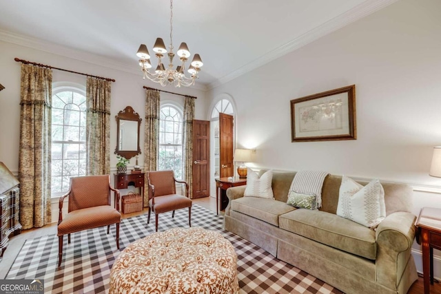 living room with an inviting chandelier and ornamental molding