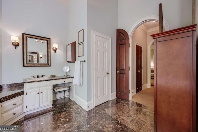 bathroom featuring tile patterned floors, vanity, and a high ceiling