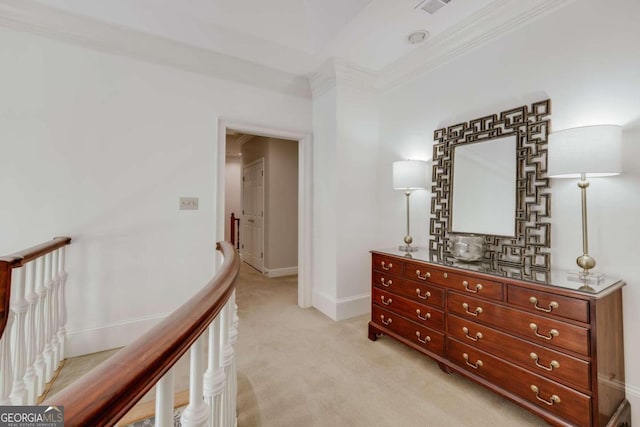 corridor featuring light carpet, baseboards, ornamental molding, and an upstairs landing