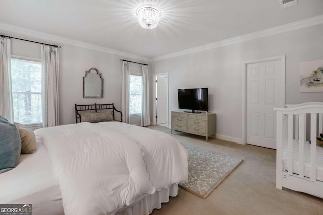 carpeted bedroom with ornamental molding, multiple windows, and baseboards