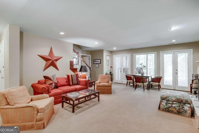 living area with stairs, french doors, light carpet, and recessed lighting