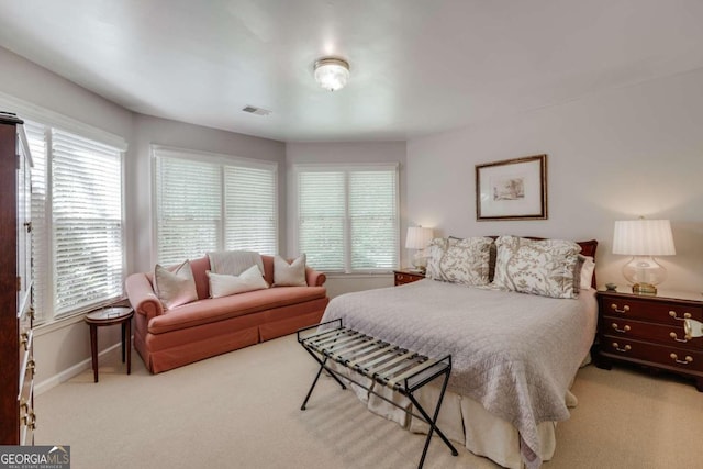 bedroom with carpet floors, visible vents, and baseboards