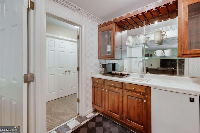 bar with dark floors, refrigerator, a sink, and wallpapered walls