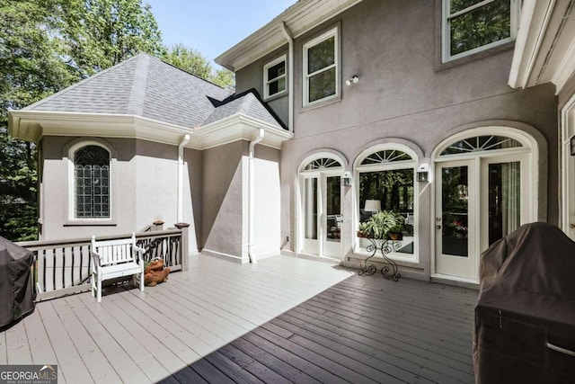 wooden terrace featuring a grill