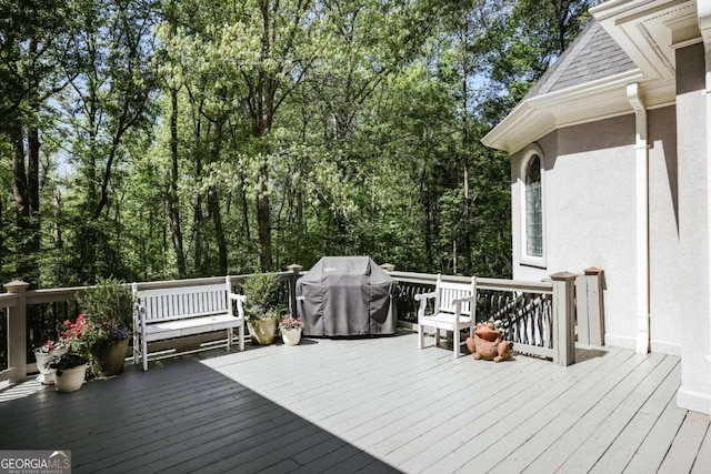 wooden terrace featuring a grill