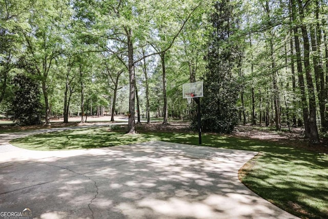 view of community with basketball court and a yard