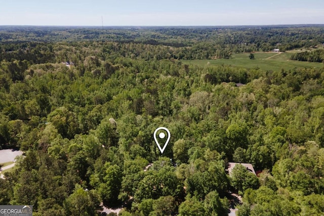 birds eye view of property featuring a wooded view