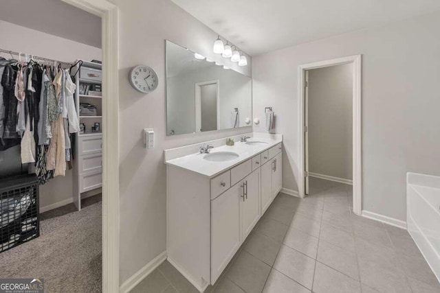 bathroom featuring tile patterned flooring, vanity, and a bathtub