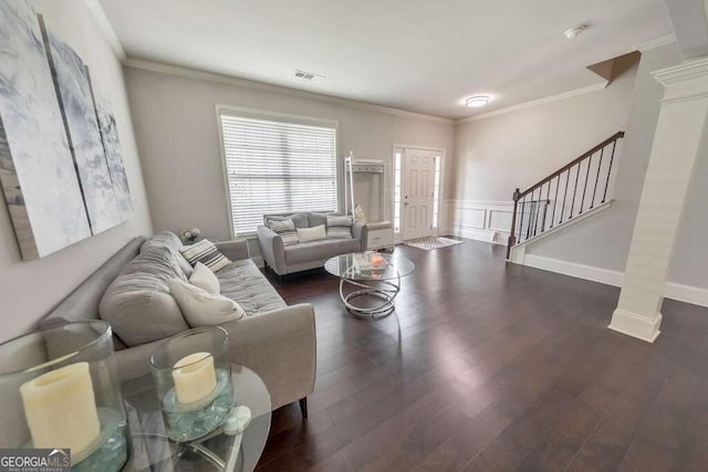 living room featuring decorative columns, ornamental molding, and dark hardwood / wood-style flooring