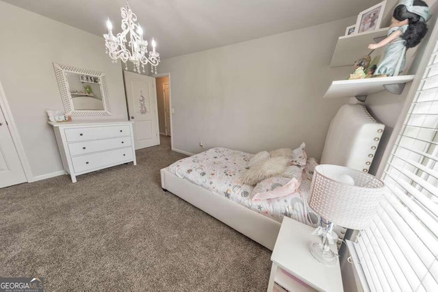 bedroom with a chandelier and dark colored carpet