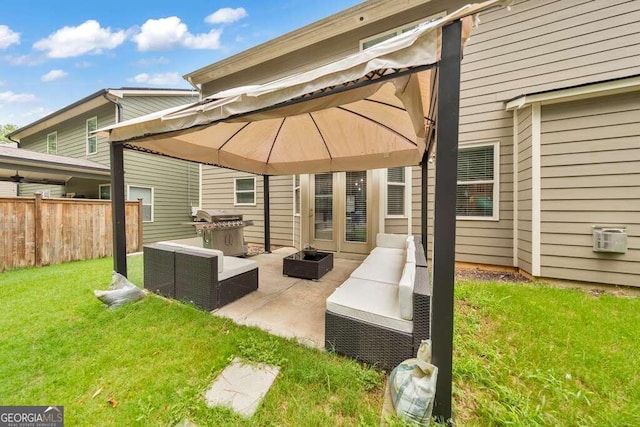 rear view of property featuring an outdoor living space, a gazebo, a patio, and a yard