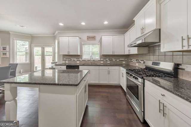 kitchen featuring white cabinetry, stainless steel range with gas cooktop, dark stone counters, and a kitchen island