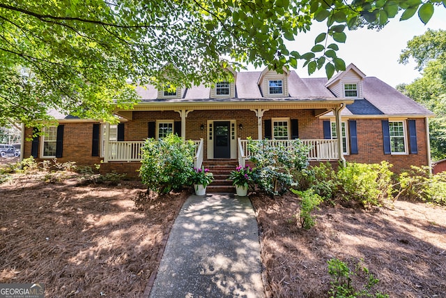 cape cod-style house featuring covered porch