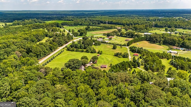 bird's eye view with a wooded view