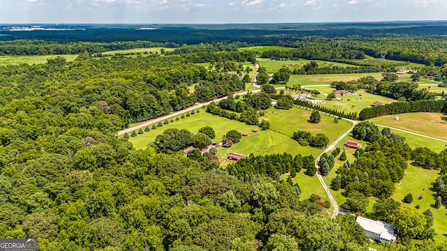 birds eye view of property with a wooded view