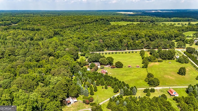 birds eye view of property with a forest view