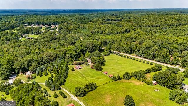 drone / aerial view featuring a wooded view