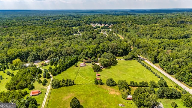 birds eye view of property featuring a forest view