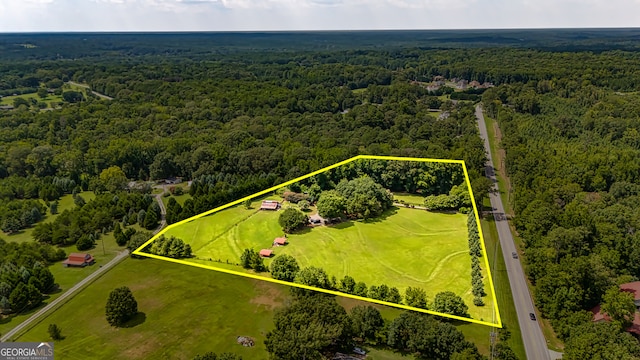 bird's eye view featuring a wooded view