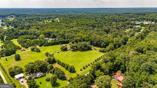 birds eye view of property featuring a view of trees