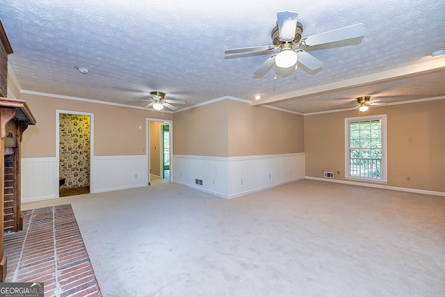 unfurnished living room with a textured ceiling, light colored carpet, crown molding, and ceiling fan