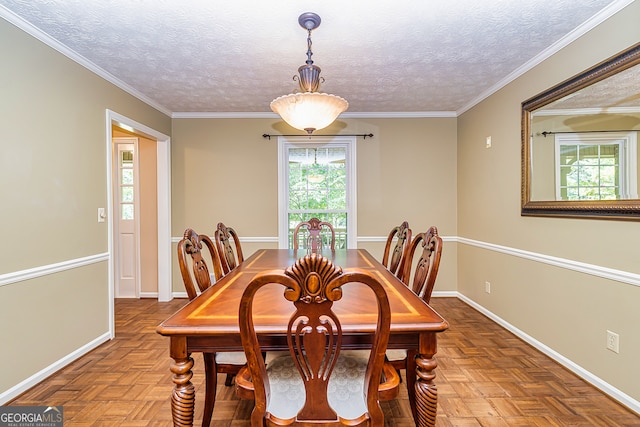 dining space featuring a textured ceiling, parquet flooring, and ornamental molding