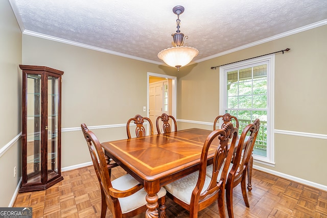 dining room featuring light parquet floors, ornamental molding, and a textured ceiling