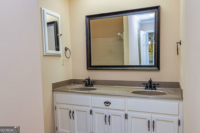 bathroom featuring ornamental molding and double vanity