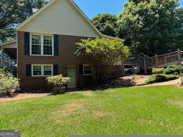 view of front facade featuring a front lawn and a wooden deck