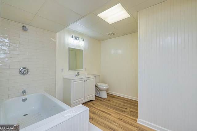 full bathroom with toilet, tiled shower / bath combo, vanity, and wood-type flooring