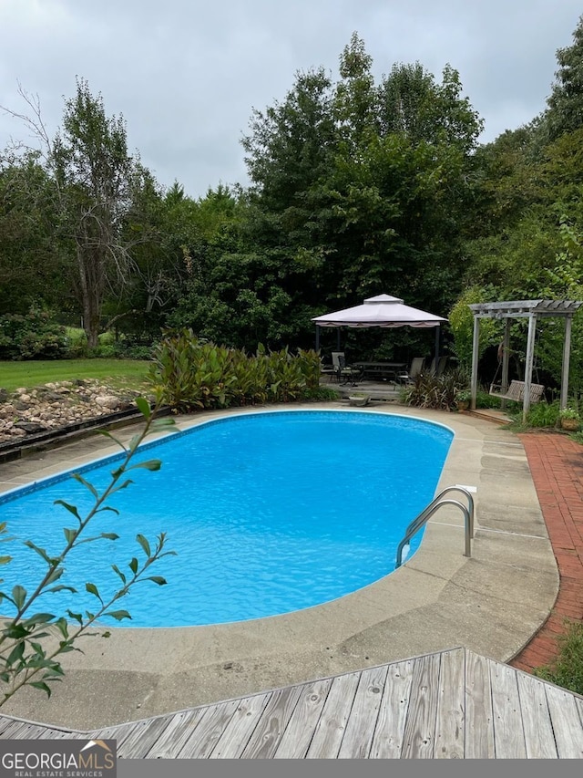 outdoor pool with a pergola and a gazebo