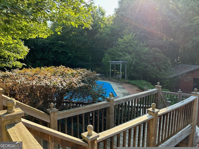 view of swimming pool featuring a wooden deck