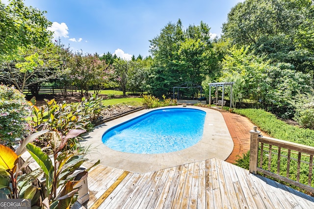 view of swimming pool featuring a wooden deck