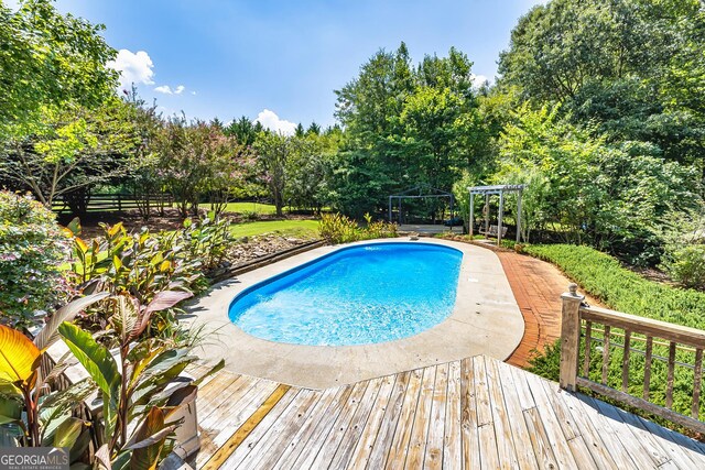 pool with a wooden deck and a gazebo