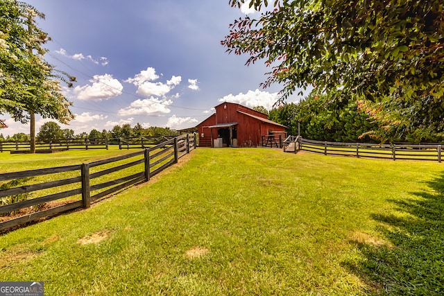 view of yard with a rural view and an outdoor structure