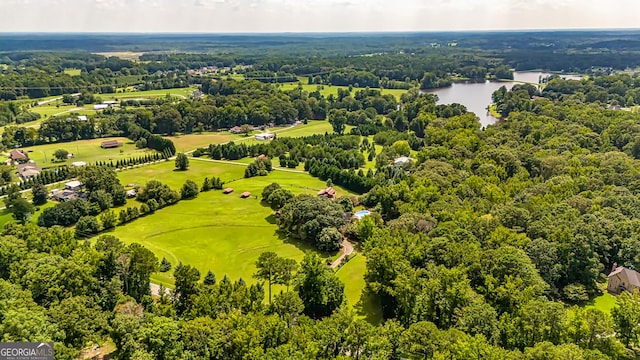 aerial view featuring view of golf course, a water view, and a view of trees