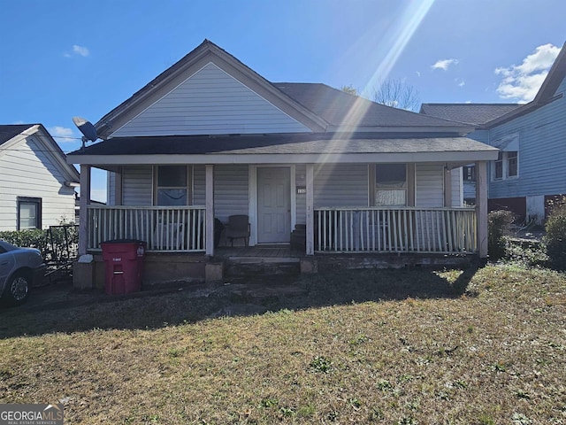 view of front of house with a porch and a front lawn