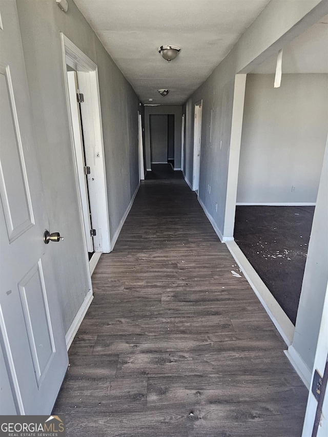 corridor featuring dark hardwood / wood-style floors