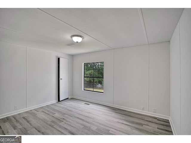 spare room with light wood-type flooring