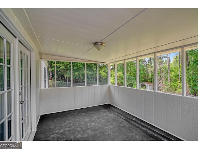 unfurnished sunroom with french doors