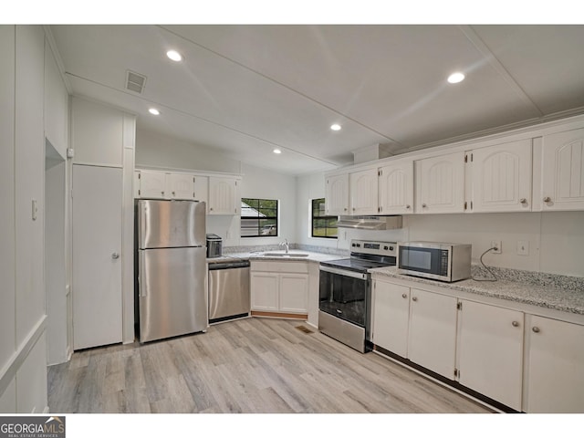 kitchen with white cabinetry, extractor fan, stainless steel appliances, sink, and light hardwood / wood-style flooring