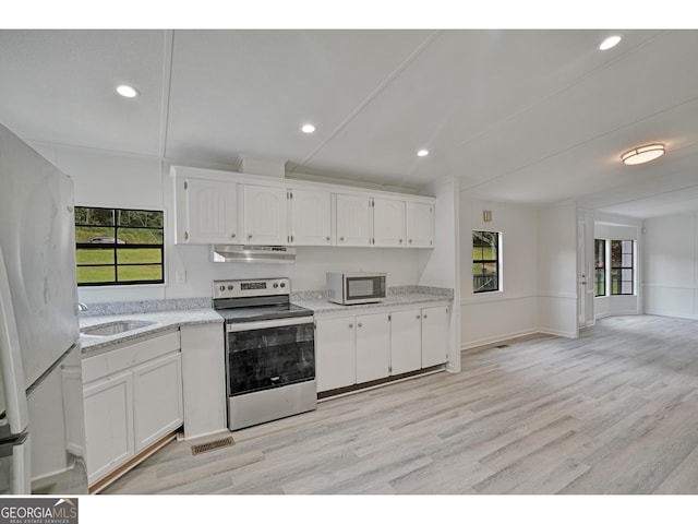 kitchen featuring a healthy amount of sunlight, sink, appliances with stainless steel finishes, and light wood-type flooring