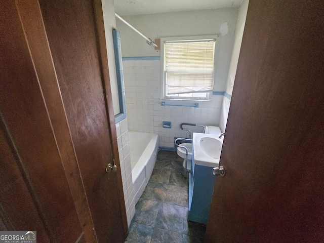 bathroom featuring tile walls, vanity, and toilet