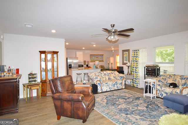 living room featuring hardwood / wood-style flooring and ceiling fan