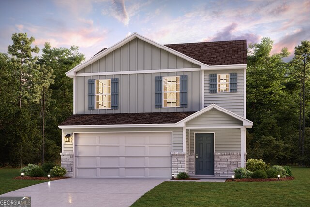 view of front of house with a garage and a yard